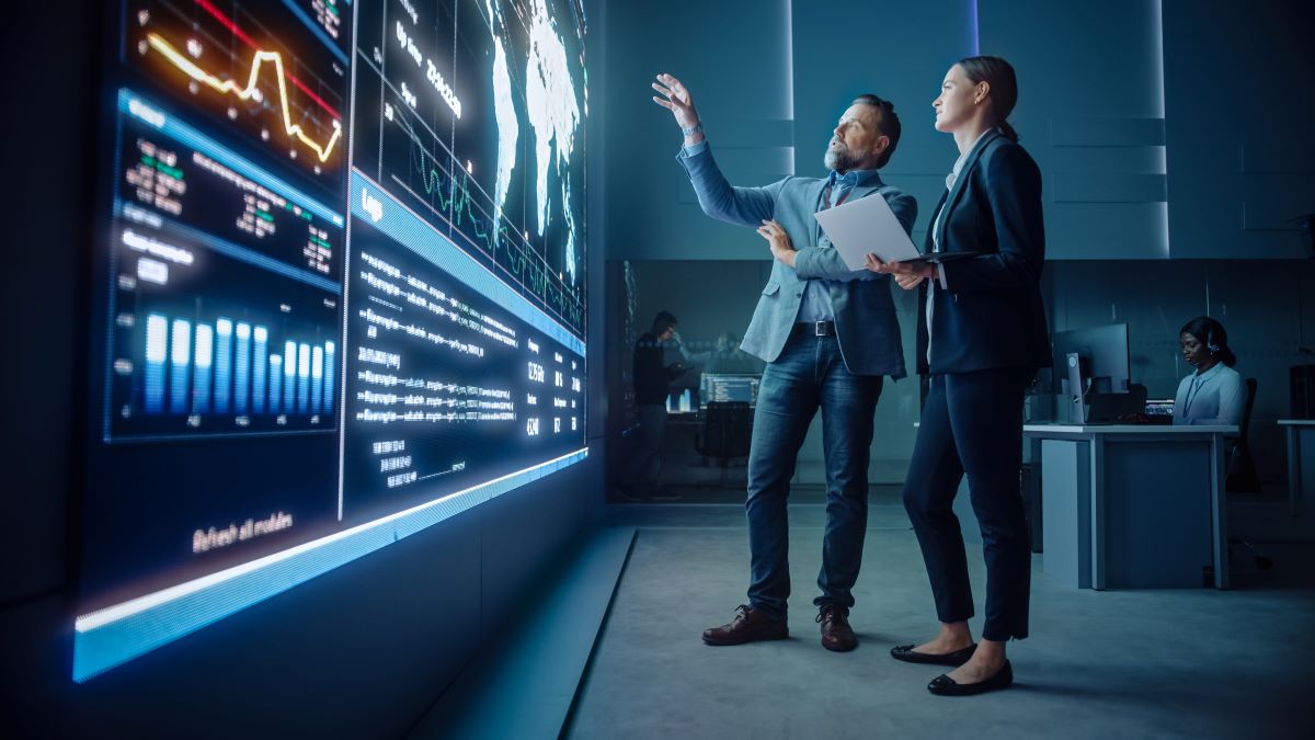two businessmen analyzing a CGI screen of data with a map