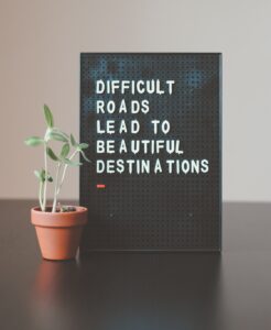 A sign that says difficult roads lead to beautiful destinations