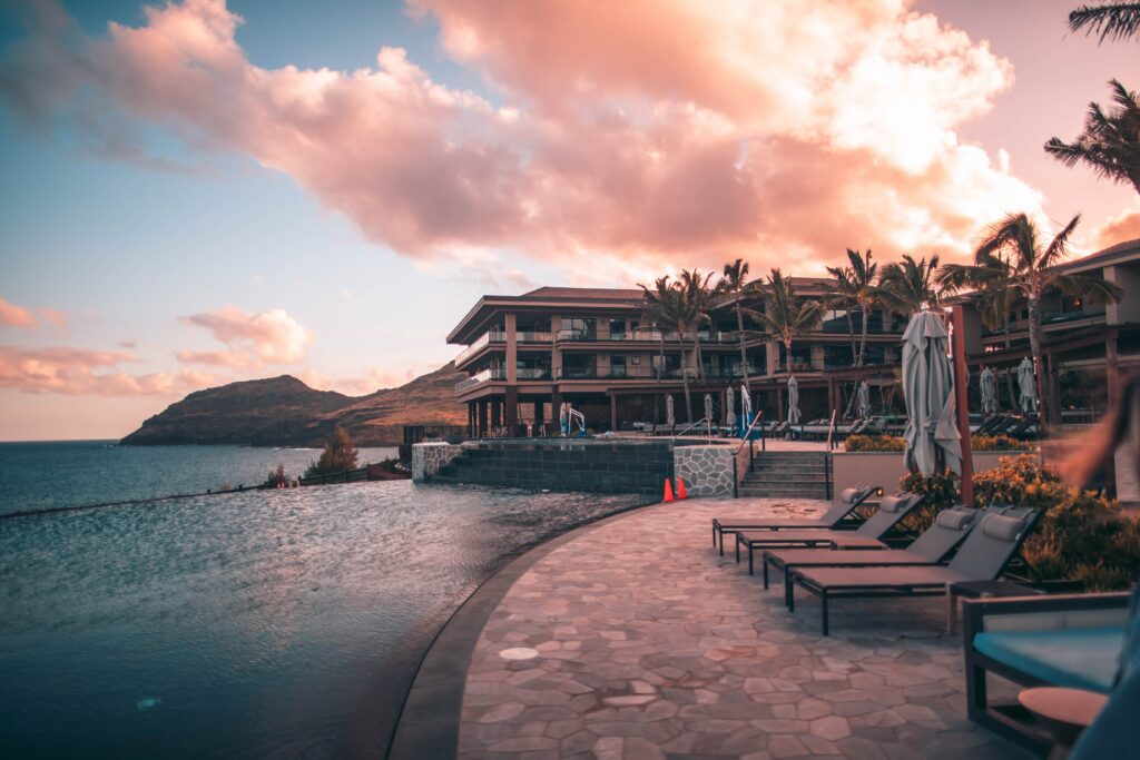 Luxury hotel with chairs beside a pool