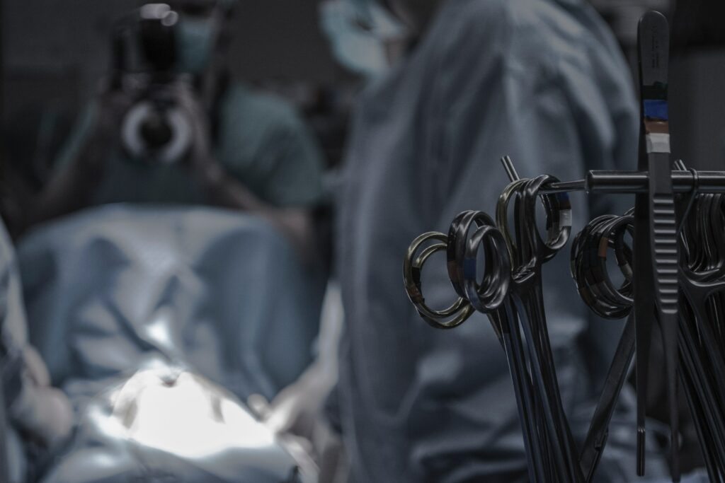 Scissors hanging in the foreground of a surgical theatre