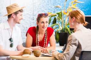 Couple in travel agency booking vacation trip
