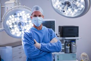 Portrait of male surgeon standing in operation theater